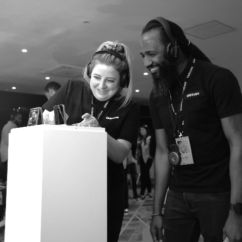 A person and person standing at a podiumDescription automatically generated