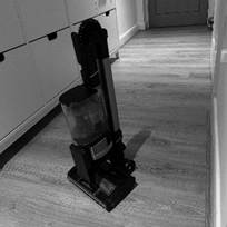 A vacuum cleaner on the floorDescription automatically generated
