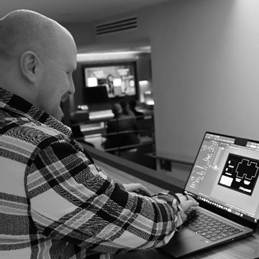 A person sitting at a desk using a computerDescription automatically generated