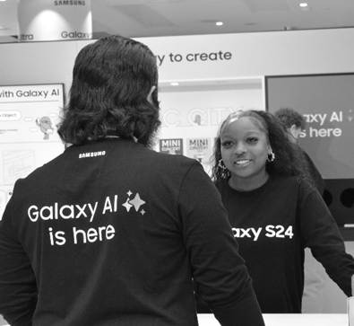 A person and person standing in front of a counterDescription automatically generated