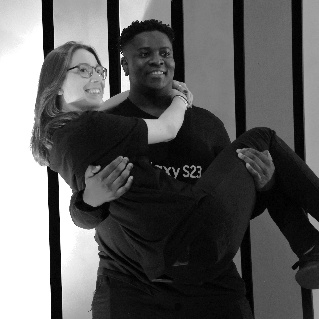 A person carrying a personDescription automatically generated