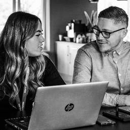 A person and person looking at a computerDescription automatically generated