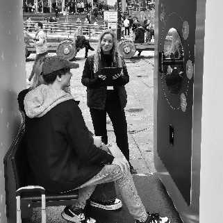 A person and person sitting on a benchDescription automatically generated