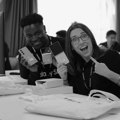 A person and person holding up cell phonesDescription automatically generated